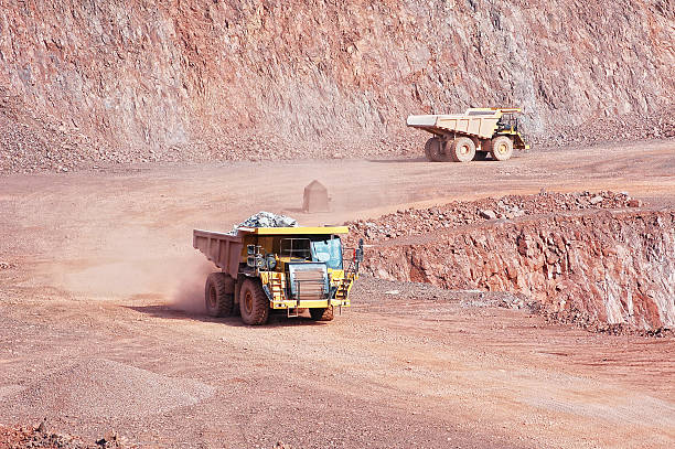 two dumper trucks in surface mine quarry. mining industry.