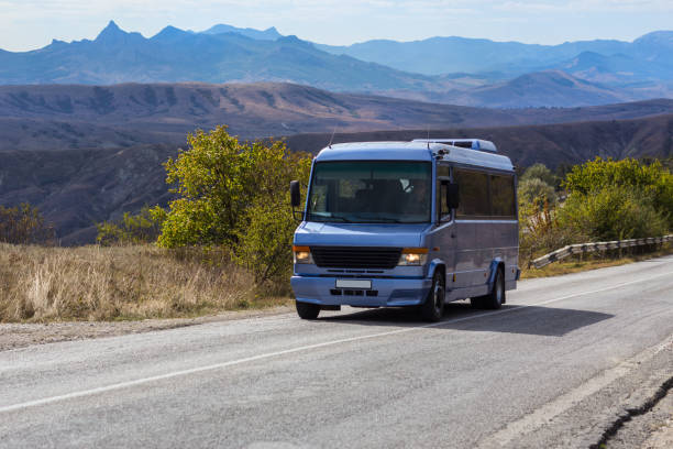 Bus moves along the road against the backdrop of a beautiful mountain landscape